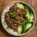 Korean bulgogi beef with jasmine rice and sesame-garlic greens.