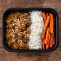 Beef massaman curry with jasmine rice and roasted carrots.